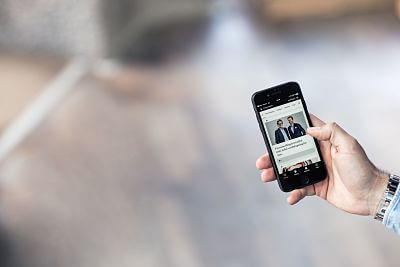 People looking at news on their phone