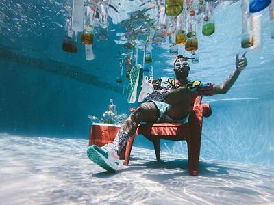 Photo of dude underwater with bottles